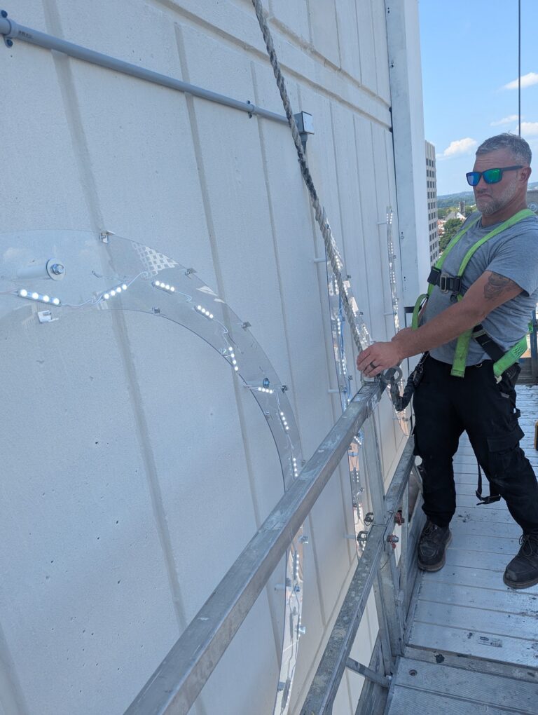 Crew installing high-rise letters