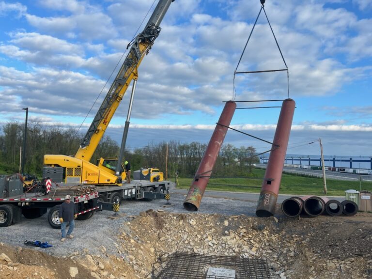Crane setting a steel pylon sign structure